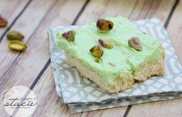Pistachio Cream Bars - Made with a shortbread cookie base and filling that is a cross between a pudding and cheesecake. This vibrantly coloured dessert is a great make-ahead dish for entertaining. The crowd pleasing flavour of pistachio will be a winner!