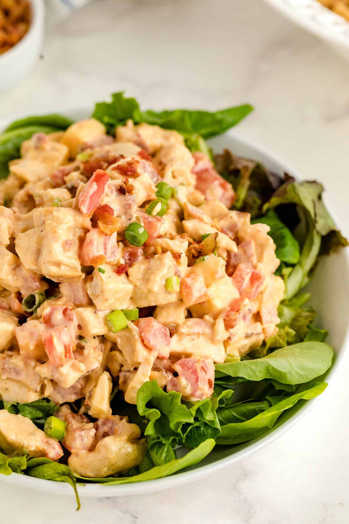 Chicken BLT Salad on a bed of lettuce.