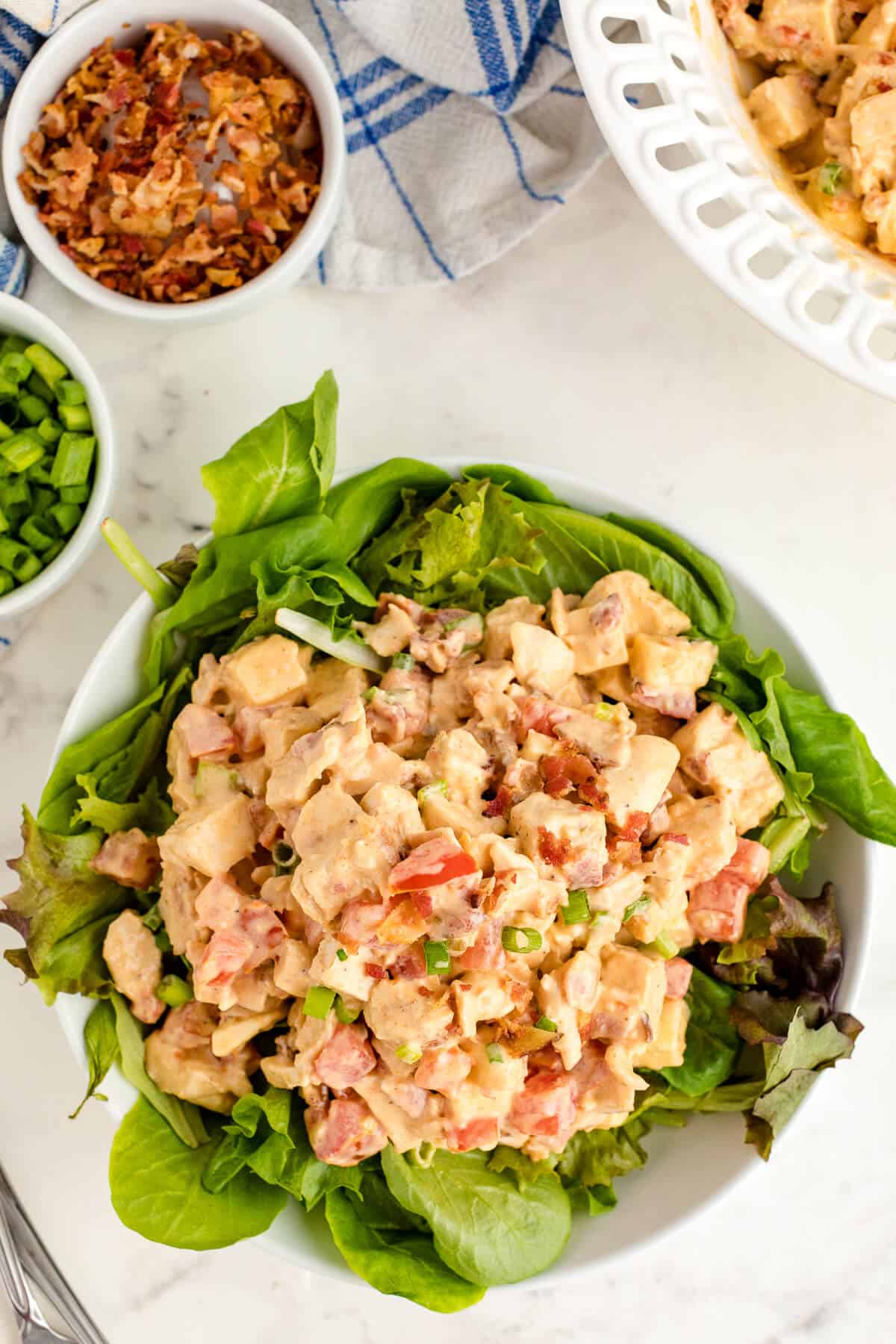 Chicken BLT Salad on a bed of lettuce.