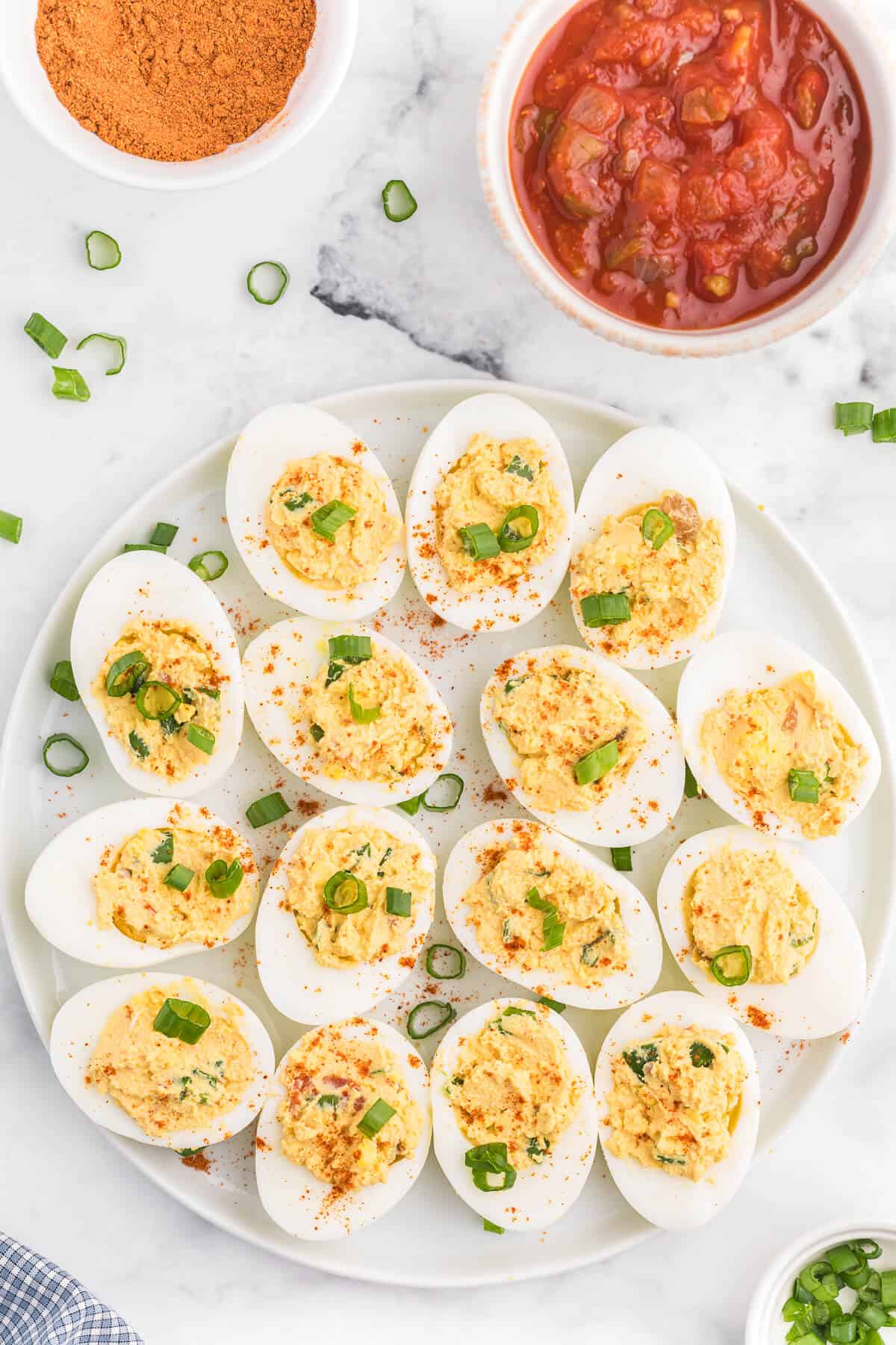 Salsa Deviled Eggs - a spicy kick to a popular appetizer recipe! This recipe is always gobbled up quickly.