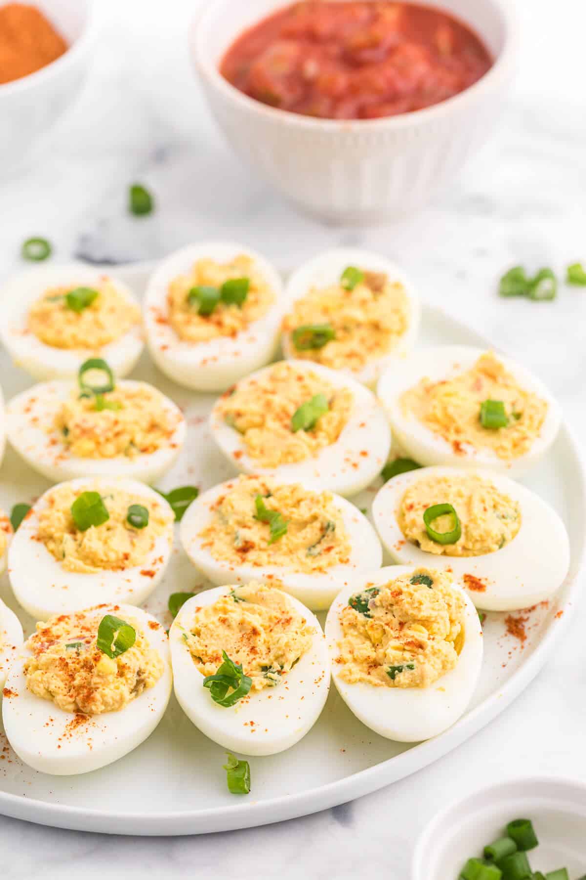 Salsa Deviled Eggs - a spicy kick to a popular appetizer recipe! This recipe is always gobbled up quickly.