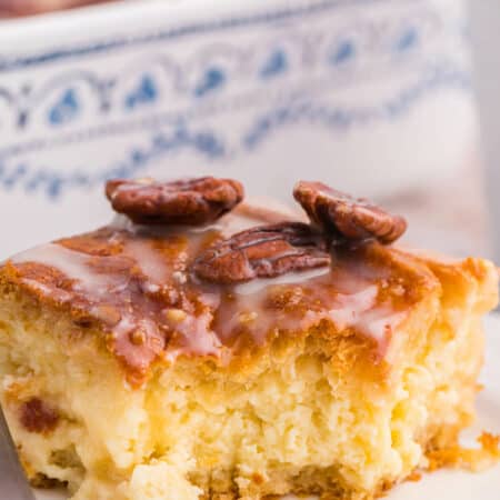 A piece of maple pecan danish bake on a plate with a bite out of it.