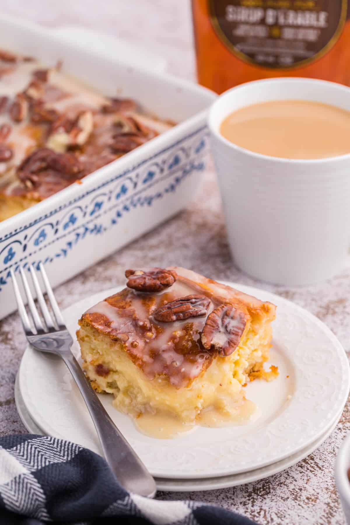 A piece of maple pecan danish bake on a plate with a fork.