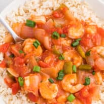 The recipe in a bowl with rice with a spoon.