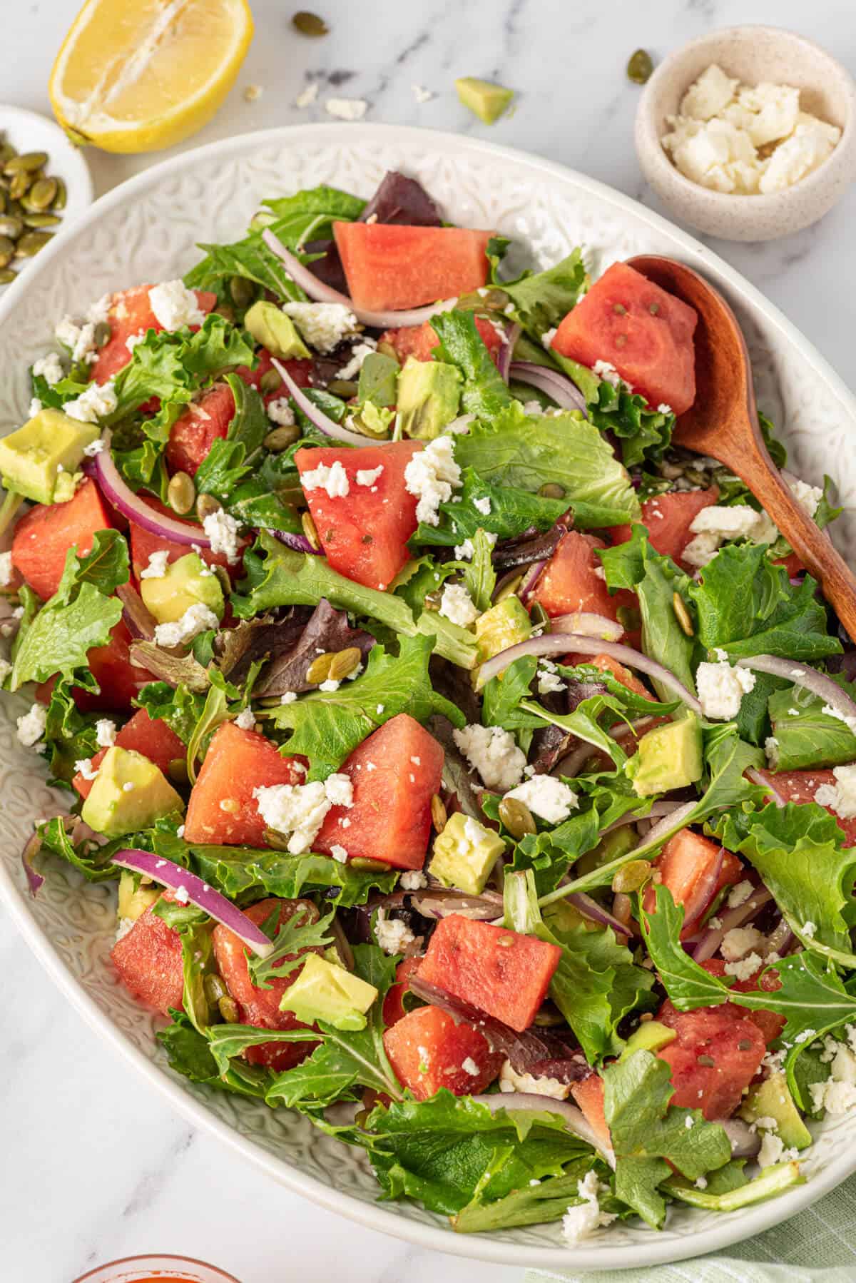 Watermelon and feta salad on a white platter.