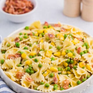 A bowl of bacon pea pasta salad.