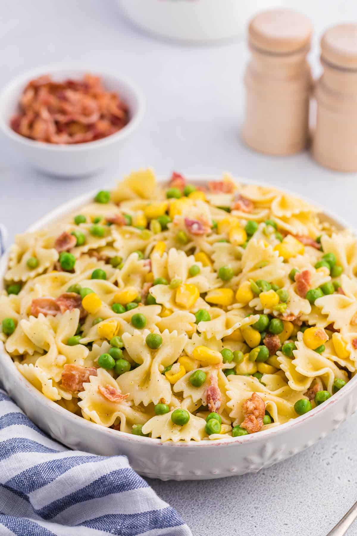 A bowl of bacon pea pasta salad.