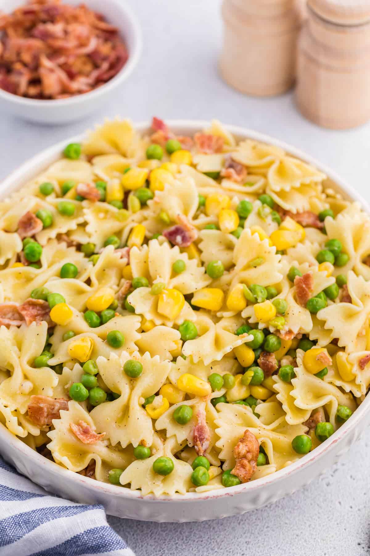 A bowl of bacon pea pasta salad.