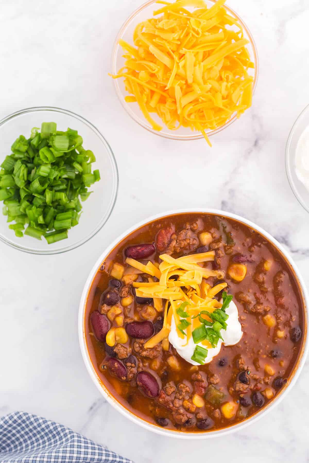 Pantry Chili - A simple, hearty soup made with just pantry staples! This beefy chili recipe is packed with corn, black beans, tomatoes, and kidney beans with a homemade seasoning blend for the best homemade chili recipe.