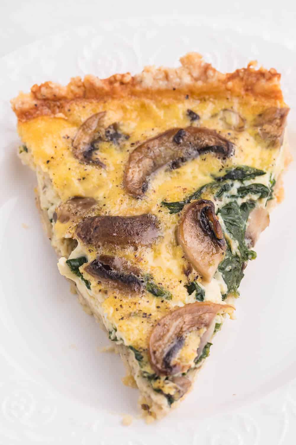 Spinach Mushroom Quiche- Fresh baby spinach, sliced mushrooms nestled in a creamy blend of eggs!