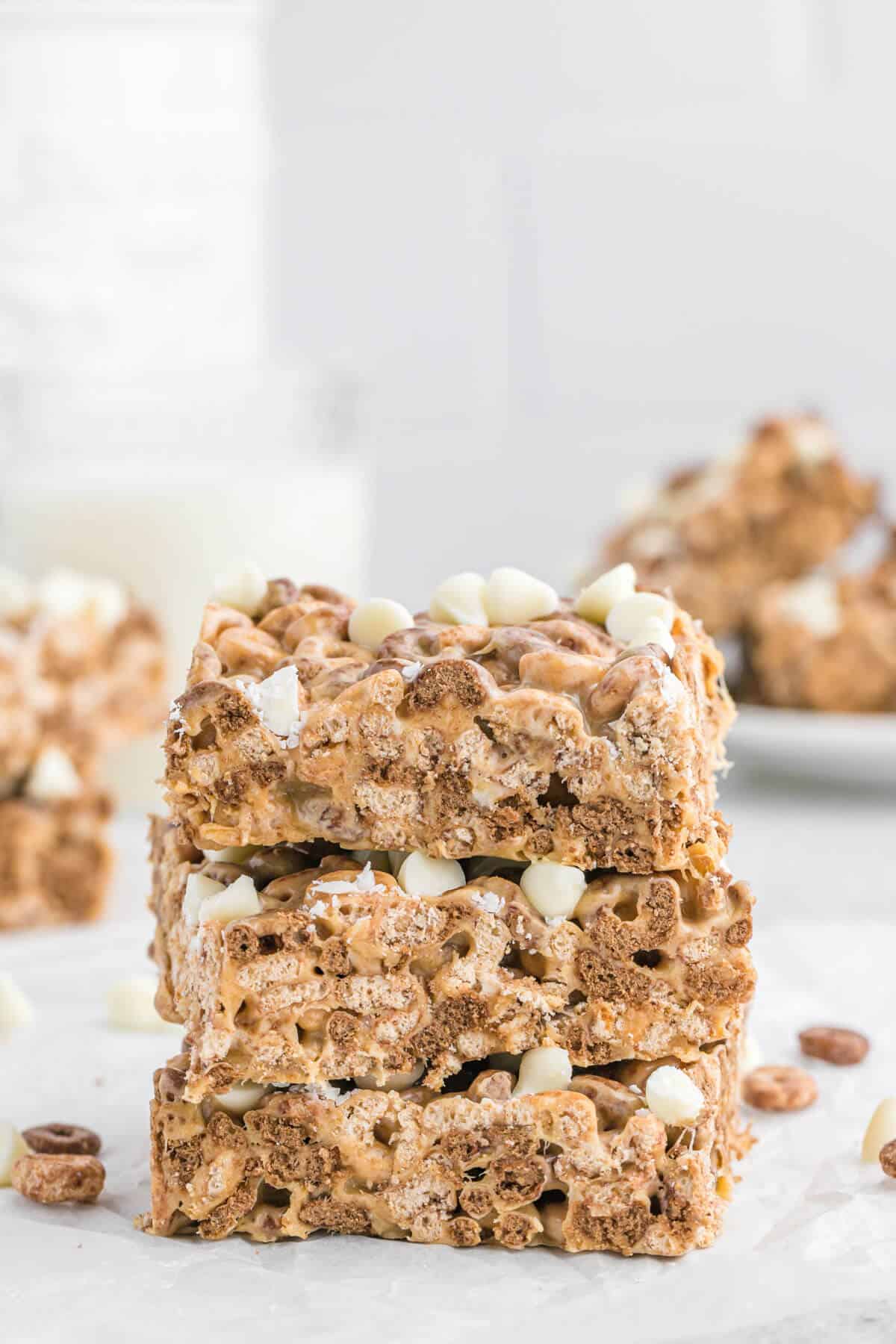 A stack of white chocolate peanut butter Cheerios treats stacked.