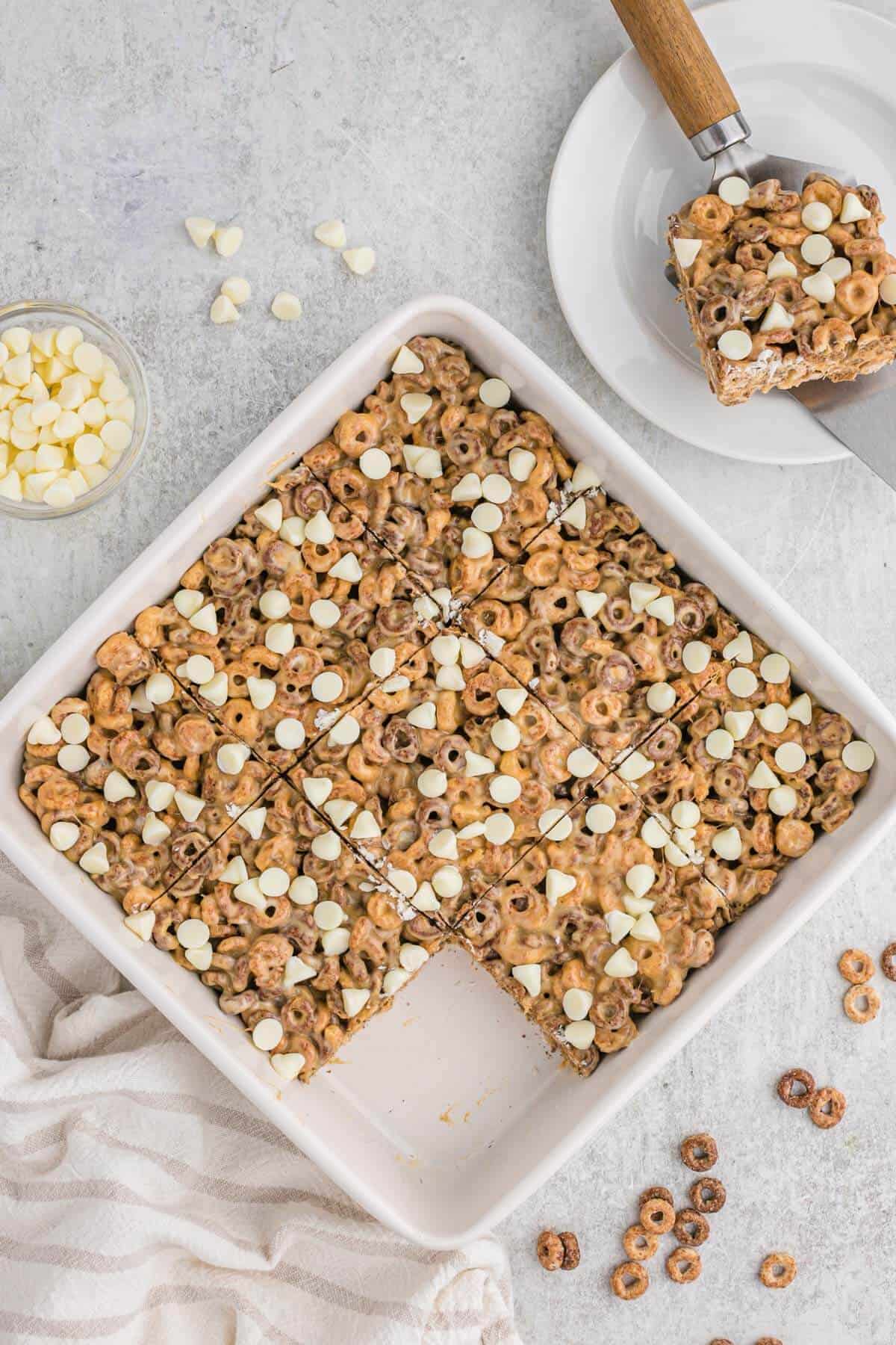 White chocolate peanut butter cheerios treats in a pan.