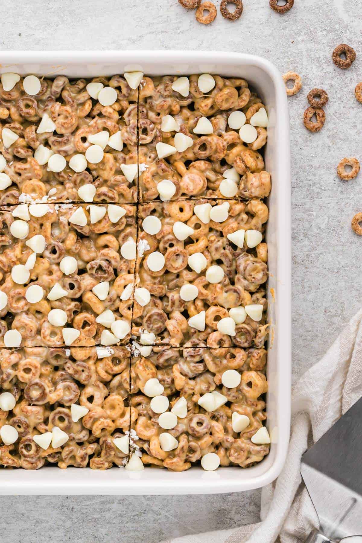 White chocolate peanut butter cheerios treats in a pan.