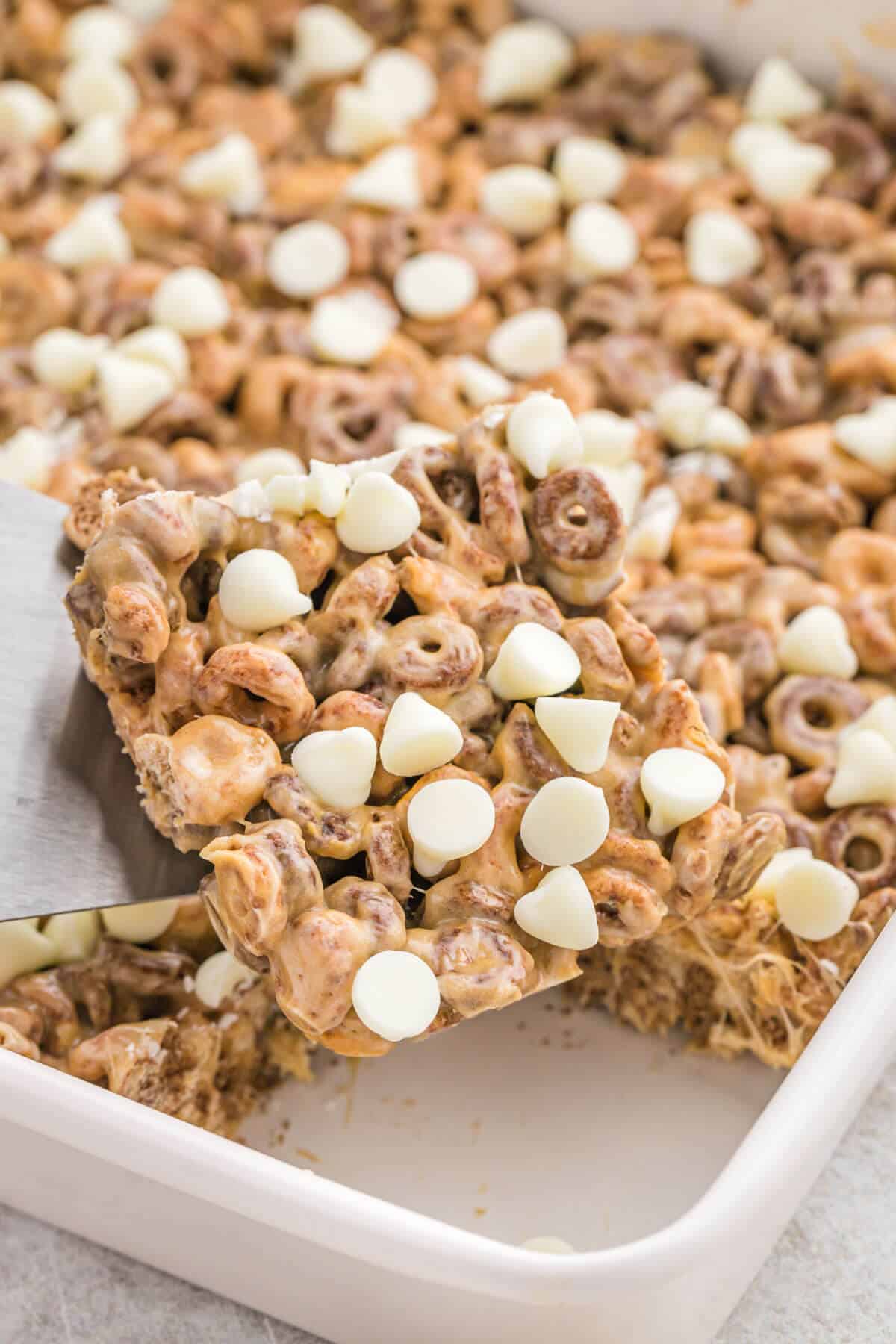 White chocolate peanut butter cheerios treats in a pan.