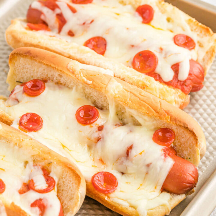 Pizza hotdogs on a baking sheet.