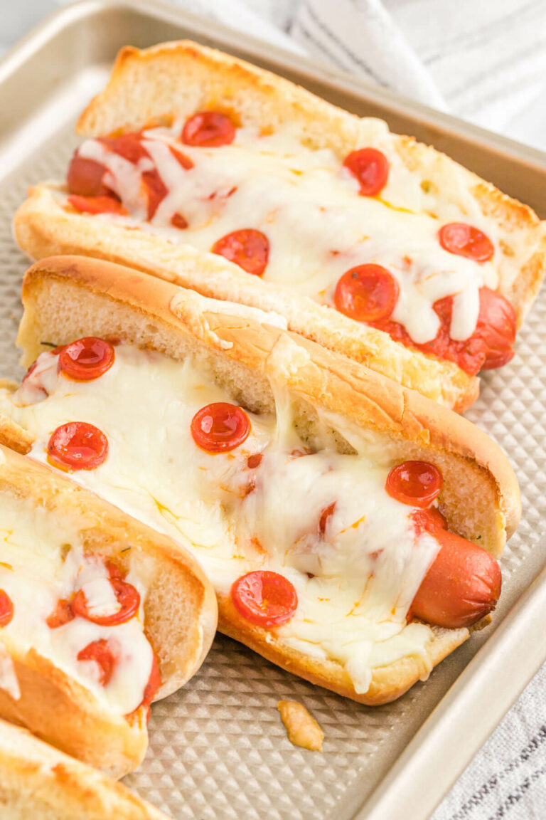 Pizza hotdogs on a baking sheet.