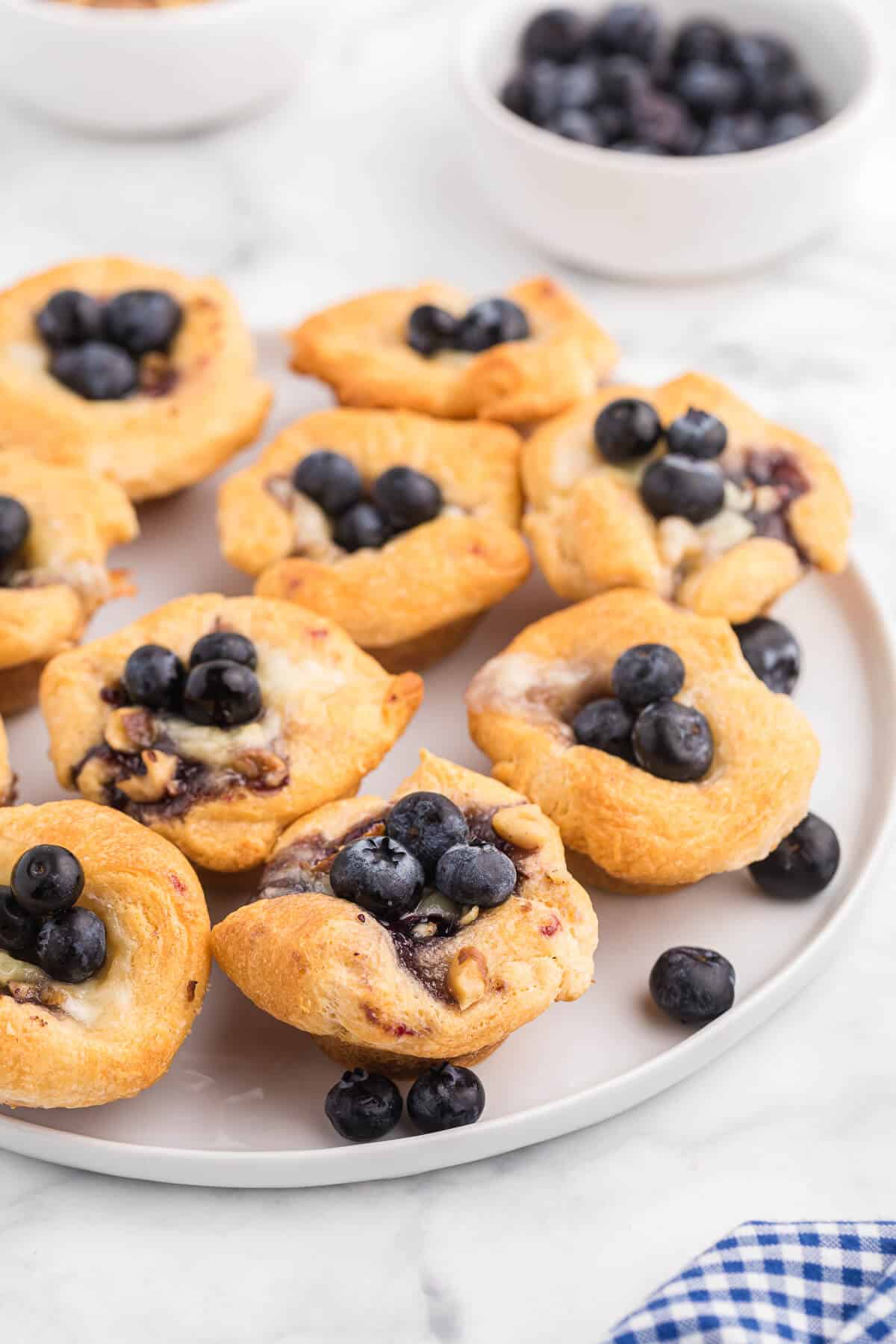 Photo of blueberry cheese tarts on a white plate