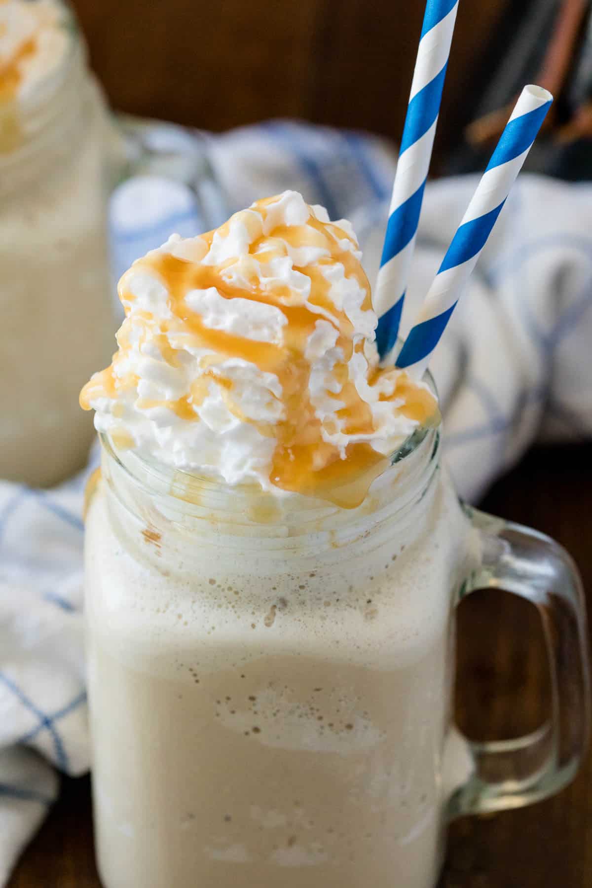 The recipe in a mug with two blue and white striped straws.