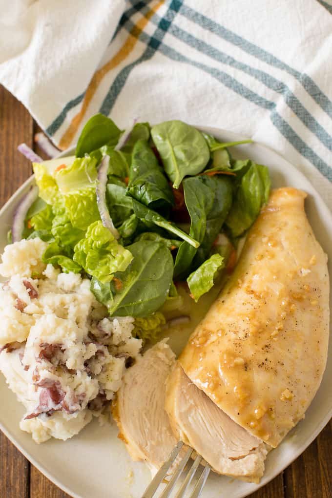 The recipe on a plate with potatoes and salad.