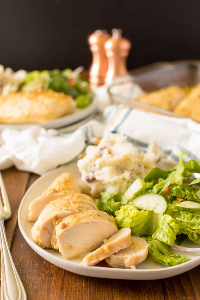 The recipe on a plate with salad and mashed potatoes.