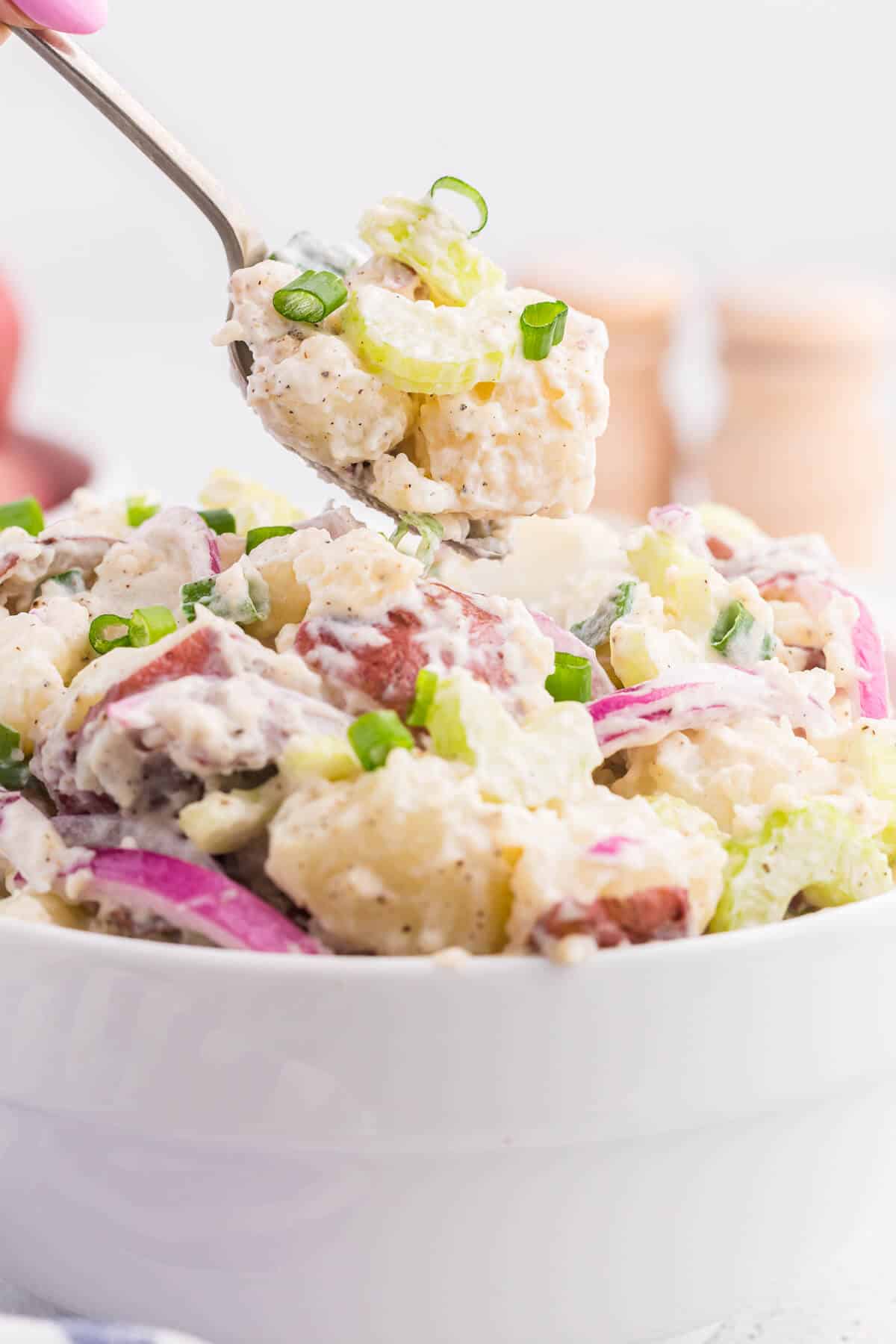 The salad on a serving spoon.