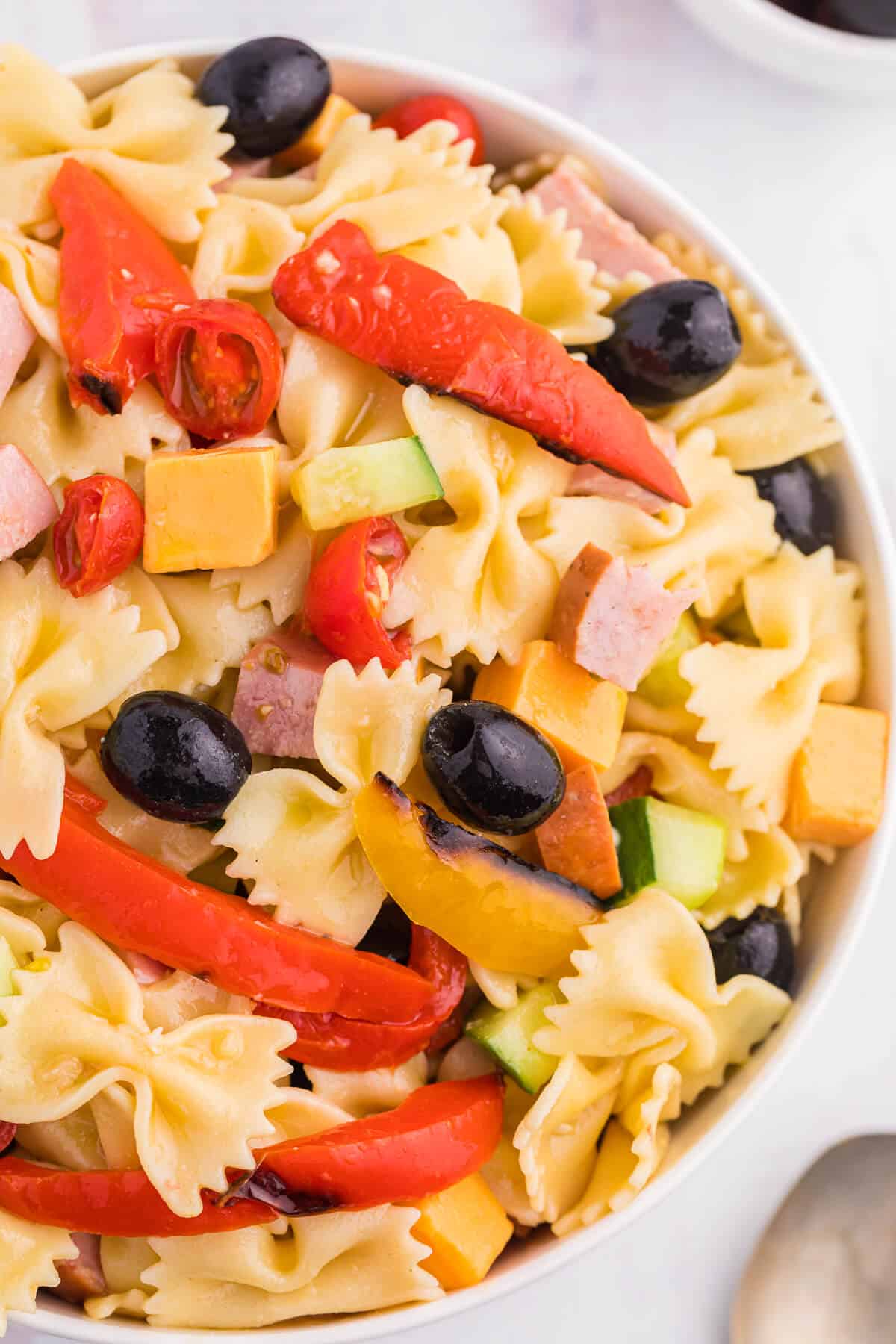 A bowl of roasted pepper pasta salad.