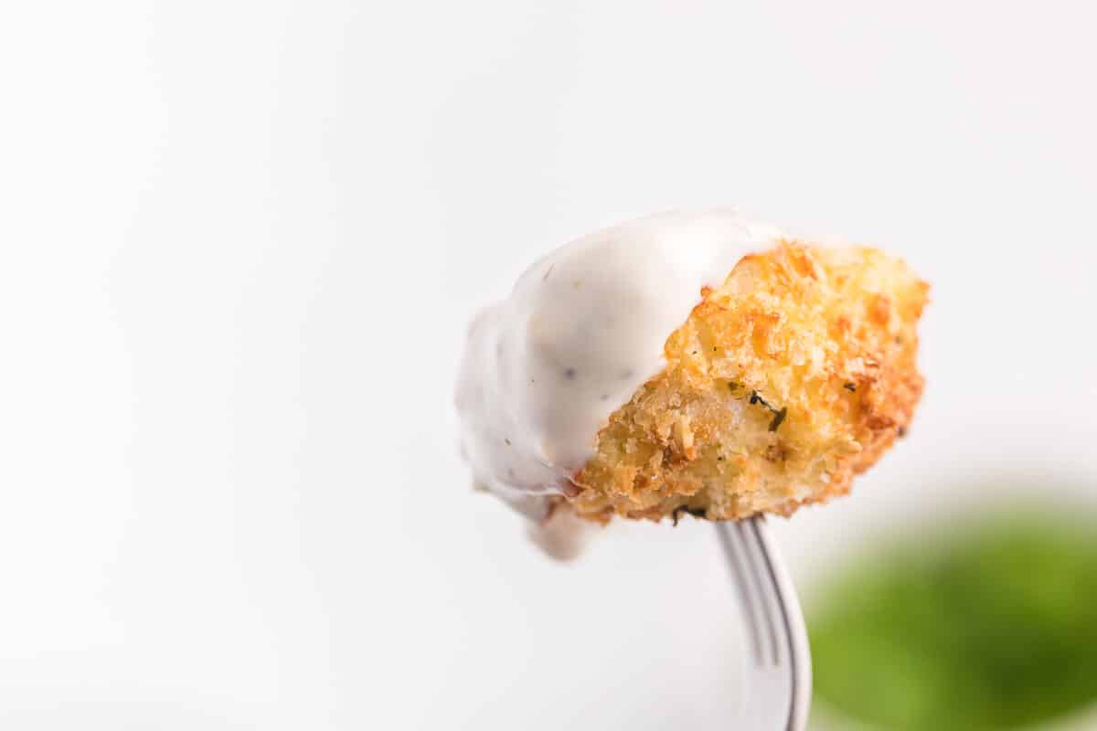 The recipe on a fork with ranch sauce.