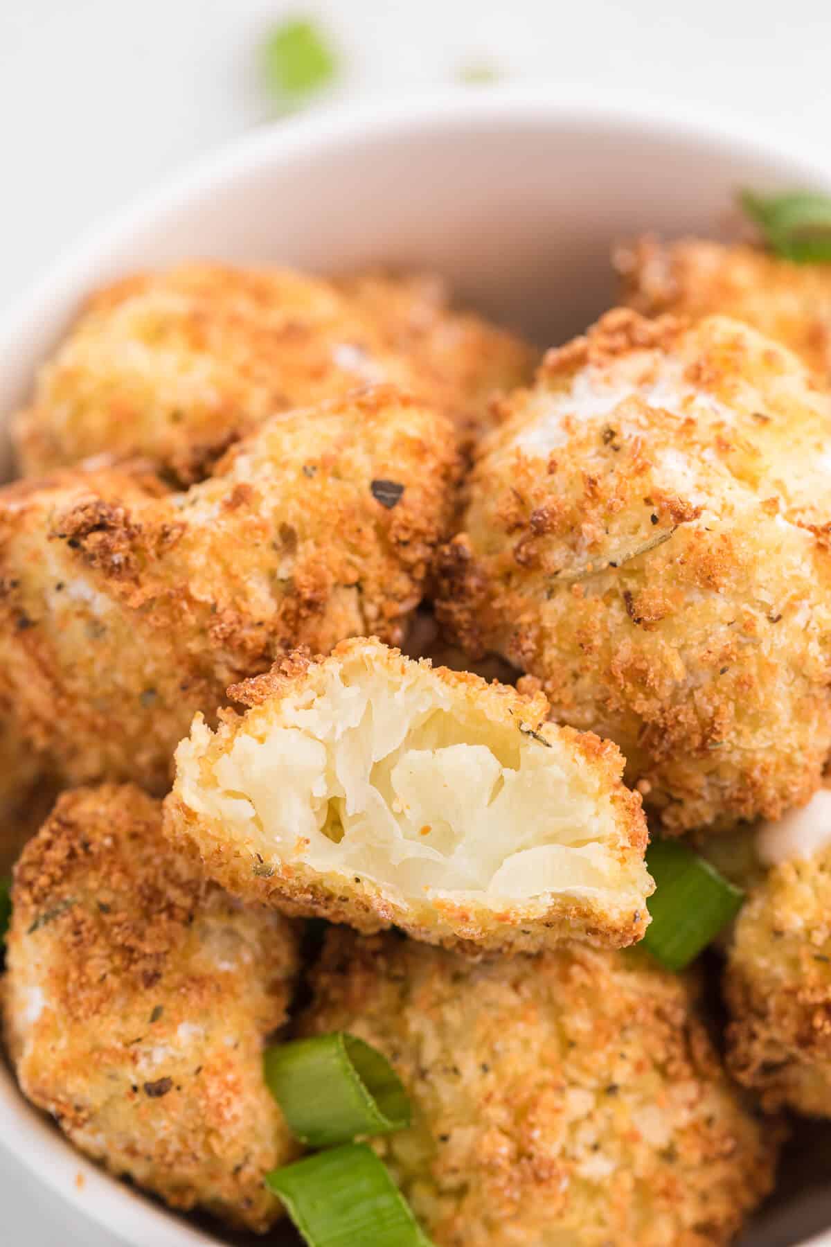The recipe in a bowl with a bite out of one.