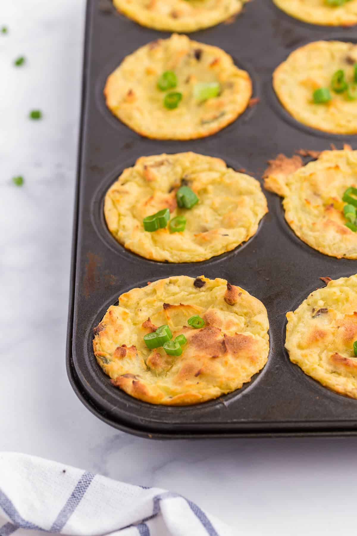 Muffin Tin Mashed Potatoes - Perfect for dinner parties! These loaded mashed potatoes are baked like savory cupcakes with mushrooms and green onions. The best way to use up leftover mashed potatoes!