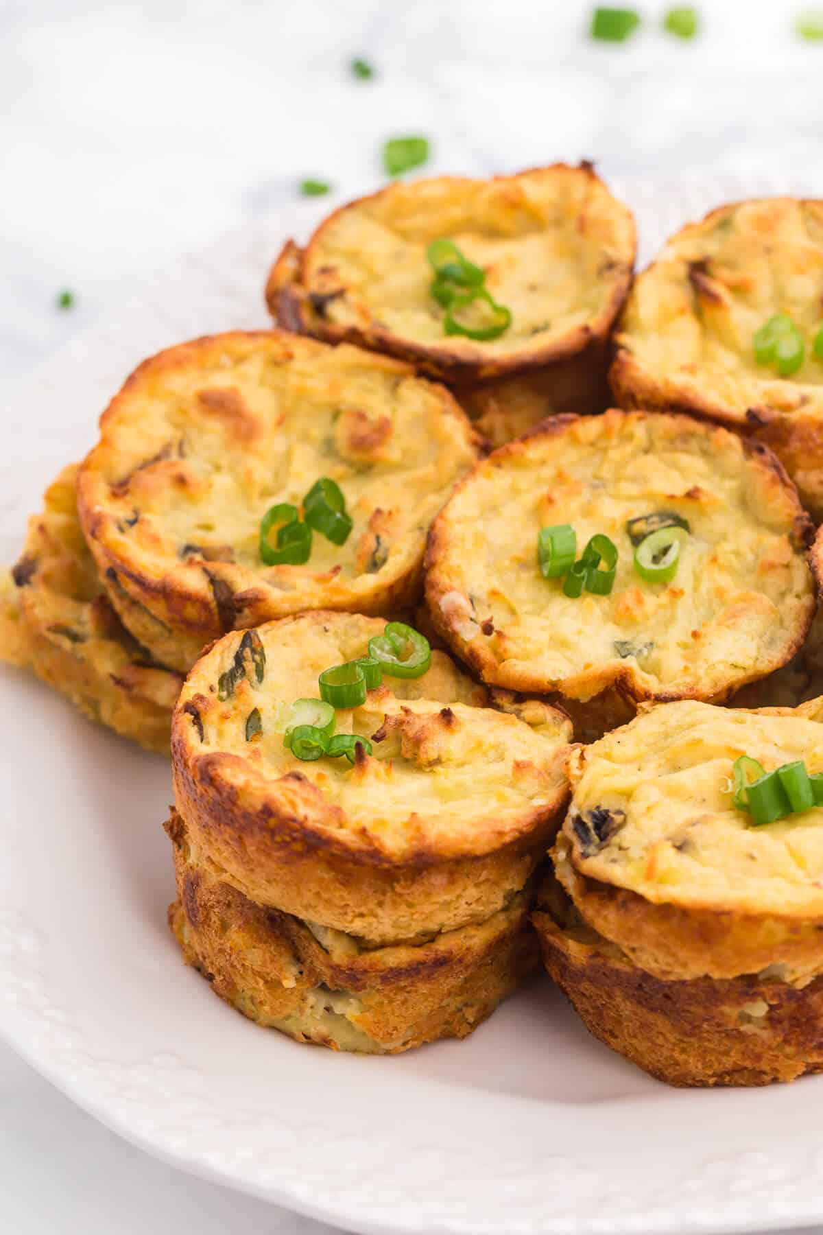 Muffin Tin Mashed Potatoes - Perfect for dinner parties! These loaded mashed potatoes are baked like savory cupcakes with mushrooms and green onions. The best way to use up leftover mashed potatoes!