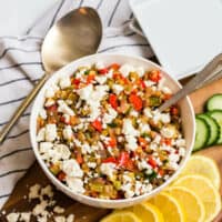 Warm lentil salad in a bowl with a spoon.