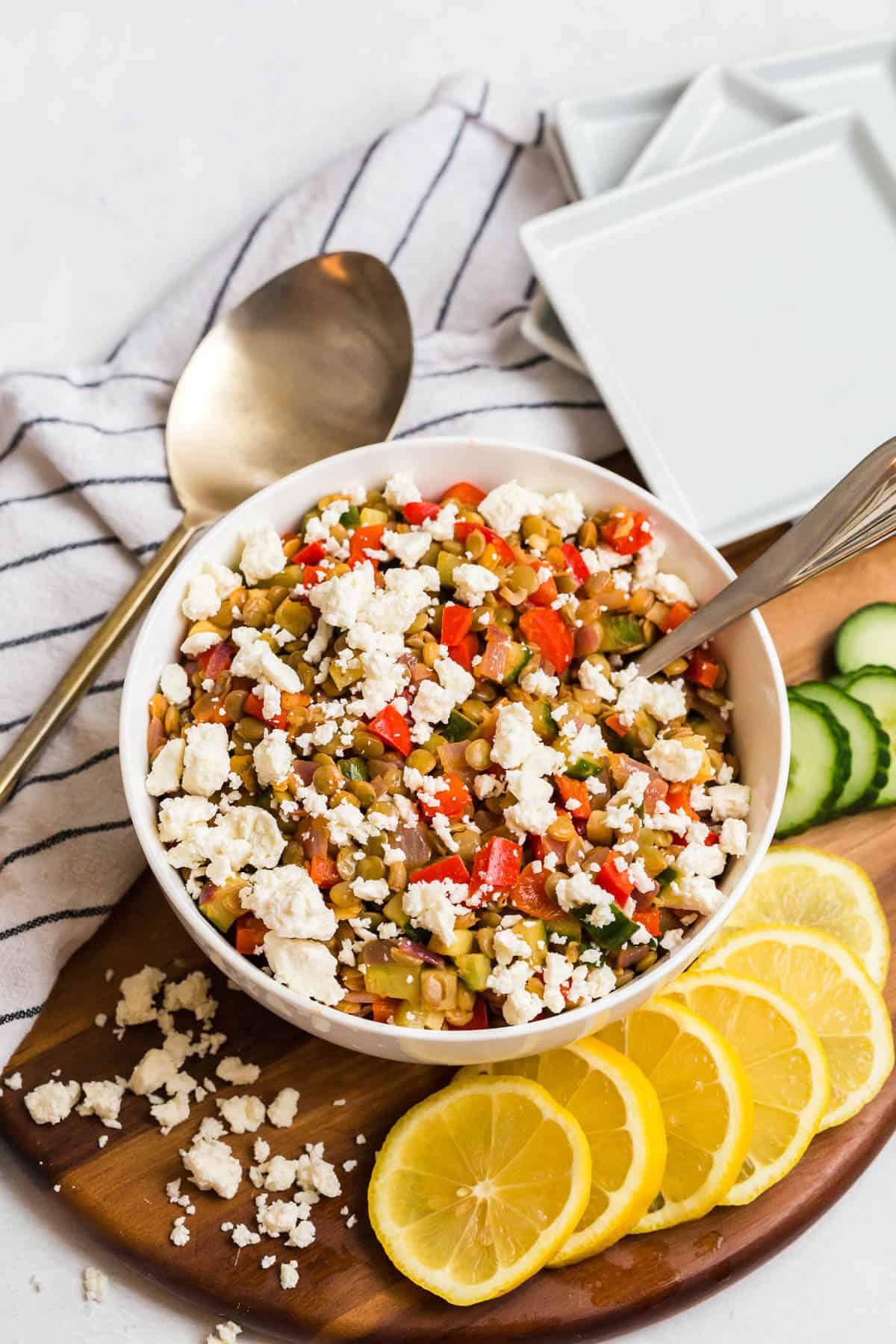 Warm lentil salad in a bowl with a spoon.