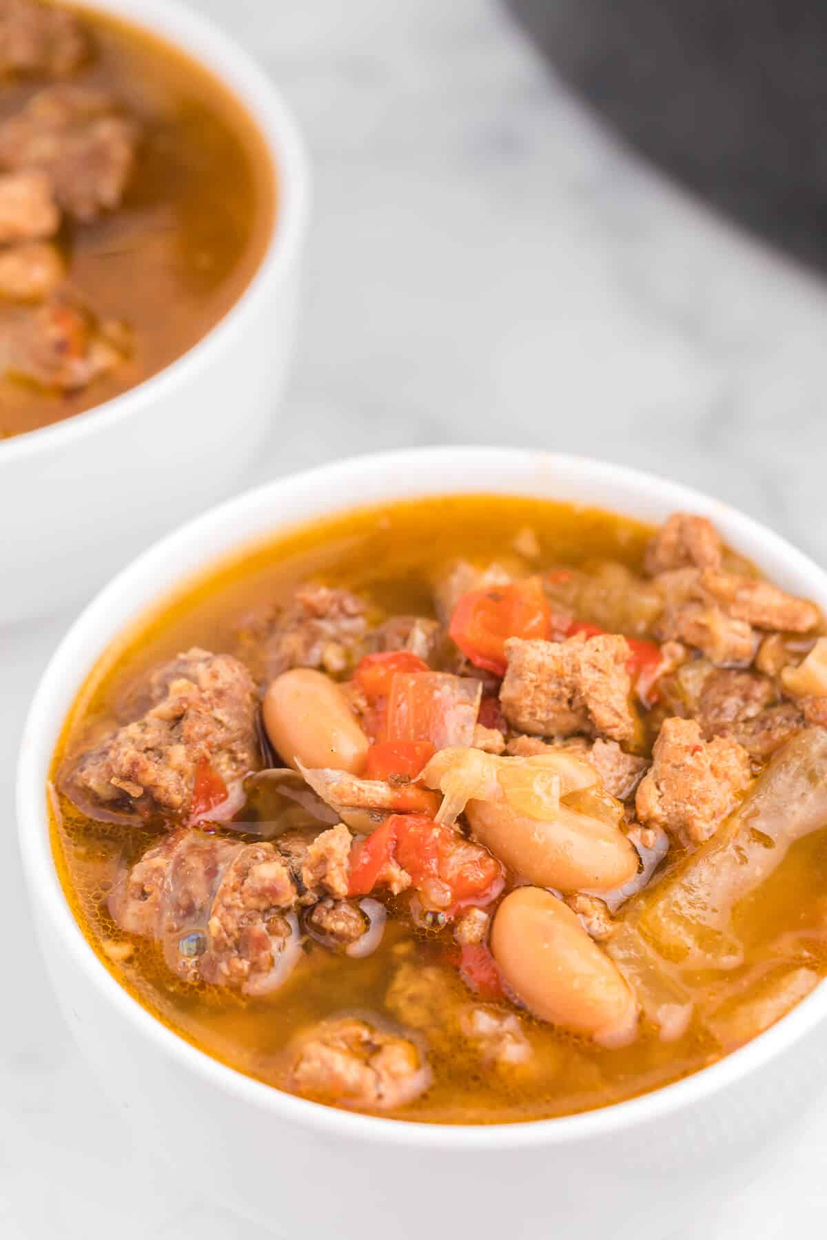 Chicken Sausage Soup - The most comforting winter soup! Load up the slow cooker with ground chicken, beer and sliced Italian sausage in this broth-based soup.