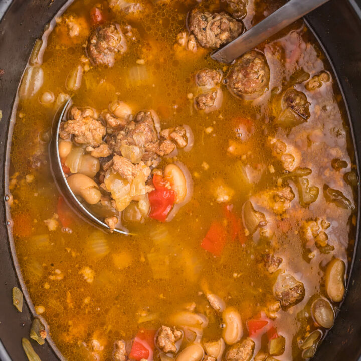 Chicken Sausage Soup is the perfect soup to whip up on a chilly day. This slow cooker soup recipe is full of beans, garlic, onion and beer for one savory soup. Pair with dinner rolls and dive in.