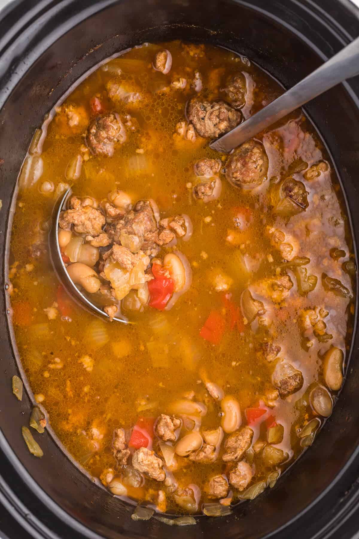 Overhead photo of soup in a crockpot with a serving spoon