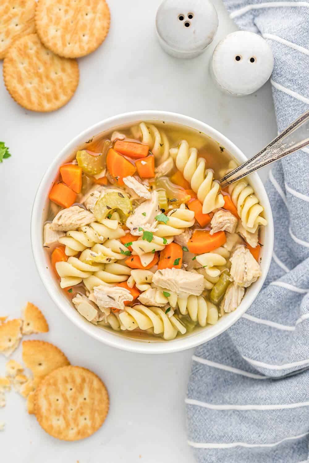 soup bowl with a spoon filled with chicken noodle soup