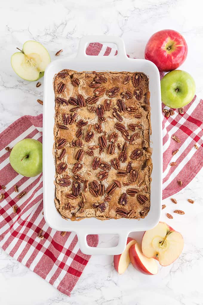 Caramel Apple Dump Cake - One of the easiest cake recipes you will find! Made with butter pecan cake mix, caramel sundae sauce, apple pie filling and pecans.