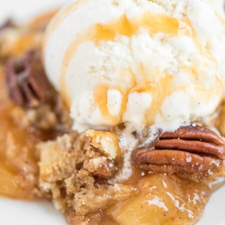 Caramel Apple Dump Cake - One of the easiest cake recipes you will find! Made with butter pecan cake mix, caramel sundae sauce, apple pie filling and pecans.