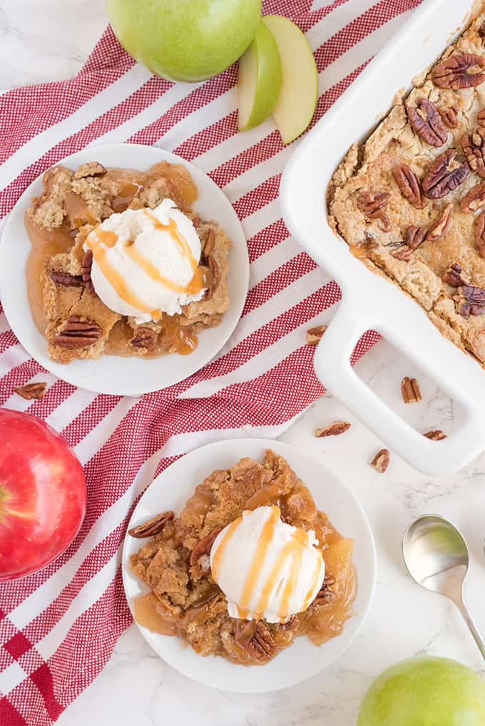 Caramel Apple Dump Cake - One of the easiest cake recipes you will find! Made with butter pecan cake mix, caramel sundae sauce, apple pie filling and pecans.