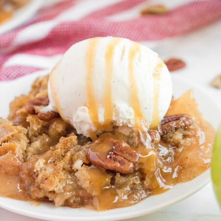 Caramel Apple Dump Cake - One of the easiest cake recipes you will find! Made with butter pecan cake mix, caramel sundae sauce, apple pie filling and pecans.