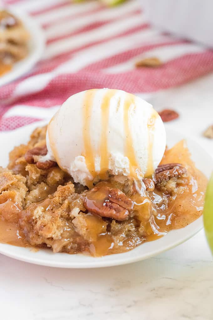 Caramel Apple Dump Cake - One of the easiest cake recipes you will find! Made with butter pecan cake mix, caramel sundae sauce, apple pie filling and pecans.