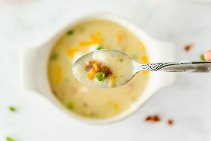 Loaded Baked Potato Soup -Your favorite side dish turned soup! This hearty soup recipe is loaded just like your favorite steakhouse — bacon, green onions, sour cream, and of course, cheese.