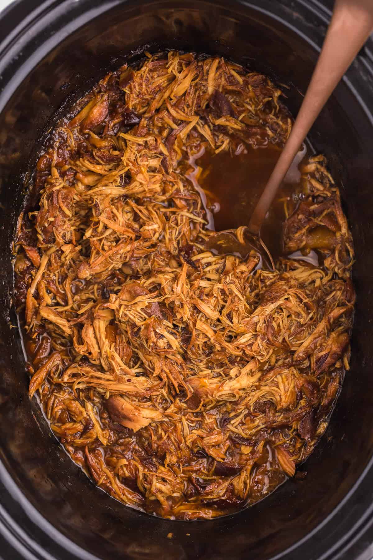 overhead shot of recipe with a serving spoon in a crockpot