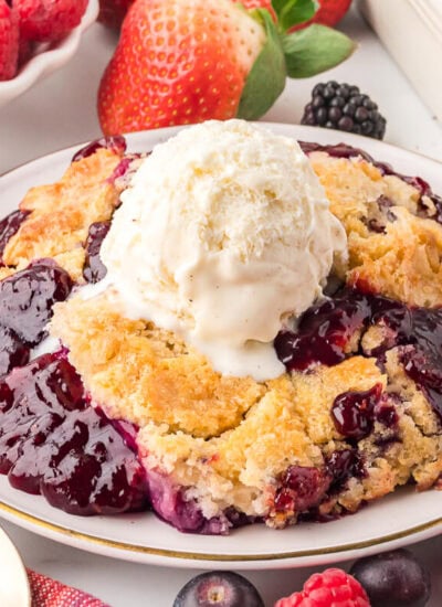 The recipe on a plate topped with a scoop of vanilla ice cream.