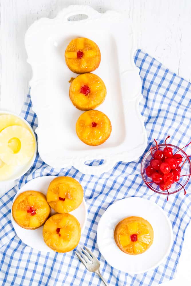 Pineapple Upside Down Cupcakes - These retro inspired cupcakes make things in the kitchen a little more convenient by using a yellow cake mix. They are moist, full of pineapple and caramel flavour and are so eye catching with the pineapple and cherry design!