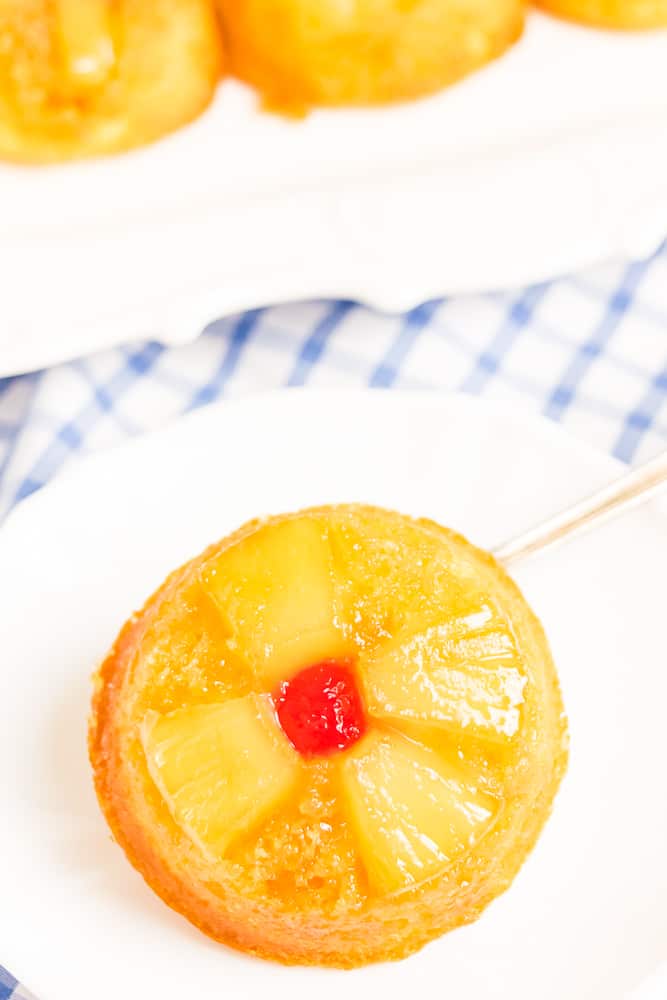 Pineapple Upside Down Cupcakes - These retro inspired cupcakes make things in the kitchen a little more convenient by using a yellow cake mix. They are moist, full of pineapple and caramel flavour and are so eye catching with the pineapple and cherry design!