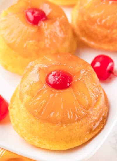 Pineapple upside down cupcakes on a platter.