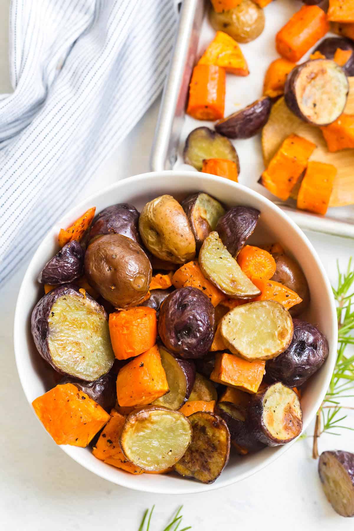 Roasted root vegetables in a white bowl.