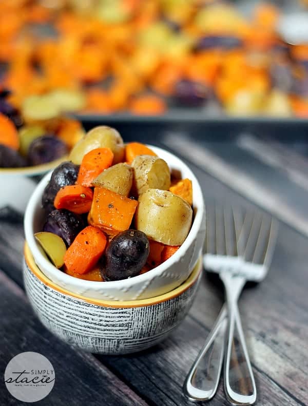 Roasted Root Vegetables - An amazing and simple fall side dish! It's such a colorful addition of carrots, fingerling potatoes, and sweet potatoes next to a roasted chicken.