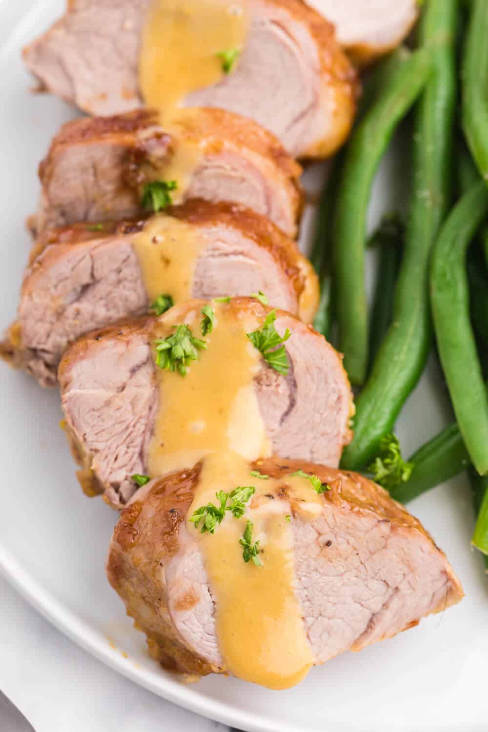 Brown Sugar Dijon Pork Tenderloin - Only two ingredients for this delicious dinner recipe! This sweet and savory glaze goes perfectly with the tender, juicy pork.